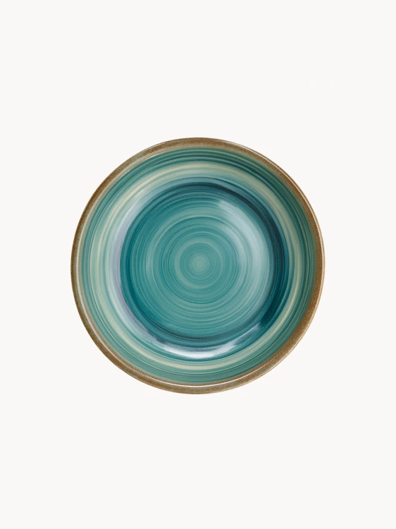 A top-down view of a round ceramic plate featuring a glossy teal and turquoise glaze with concentric swirl patterns and a brown rim.
