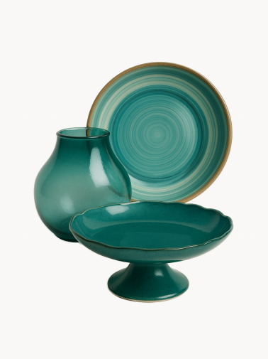 A top-down view of a round ceramic bowl with a glossy teal and turquoise swirl pattern and a brown rim. The minimalist dish is isolated against a plain white background.