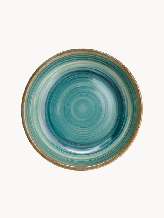 A top-down view of a round ceramic plate featuring a glossy teal and turquoise glaze with concentric swirl patterns and a brown rim.