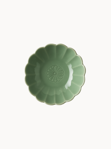 A top-down view on a small, sage green ceramic bowl designed in the shape of a blooming flower,  finished with a smooth glossy glaze, isolated on a plain white background.