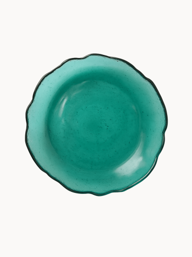 A top-down view on a vibrant teal cake stand with a distinct ruffled edge.