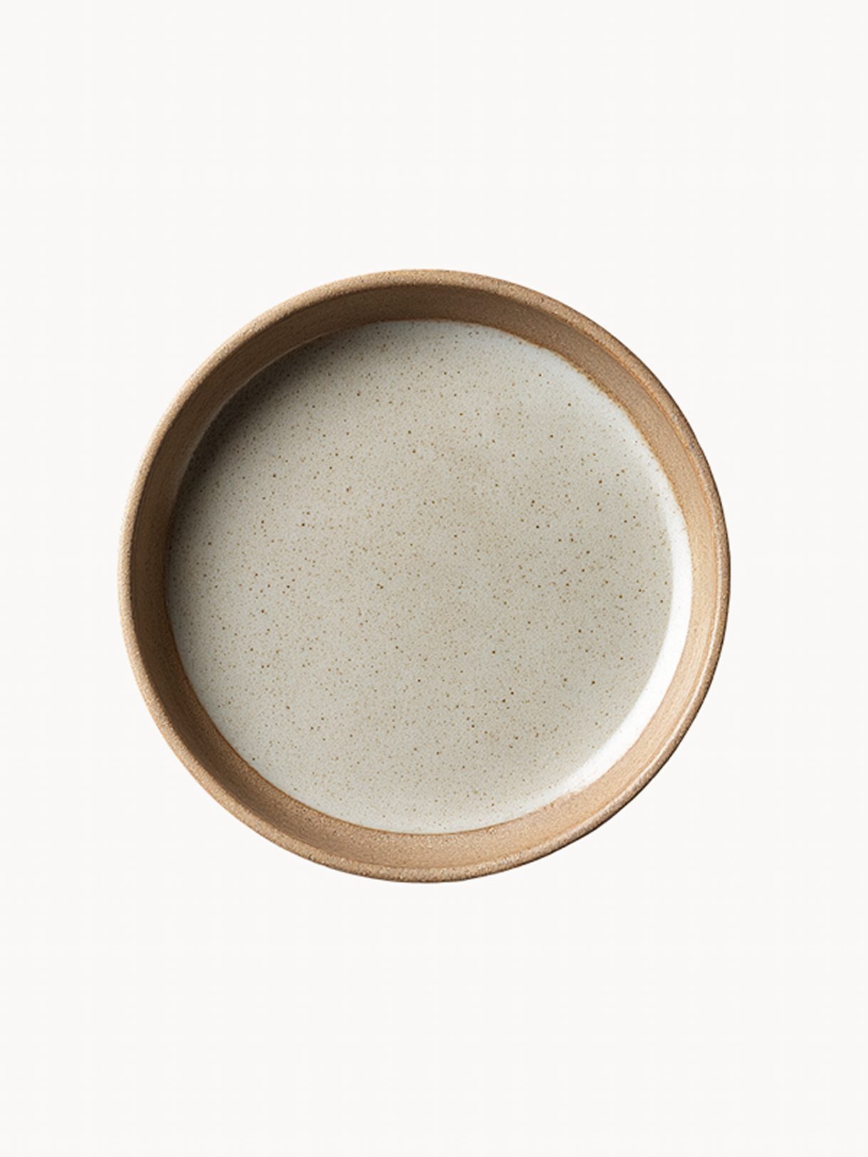 A top-down view of a round ceramic plate featuring a speckled, light grey glazed interior and a thick, unglazed natural terracotta rim.